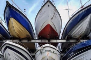 motor boats stacked on metal stands